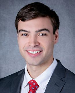 Landon in a suit and red tie