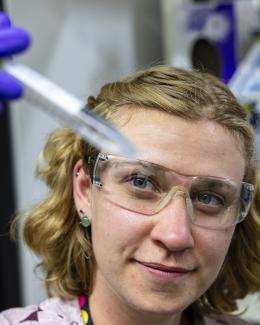 Elise holding a sample tube.