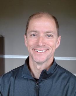 Brandon Brown headshot in grey shirt