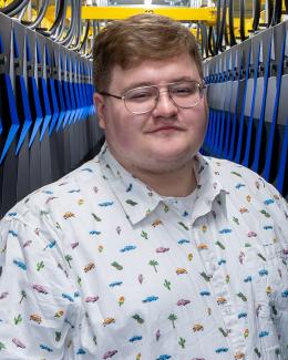 Jim in front of the now decommissioned Summit supercomputer.