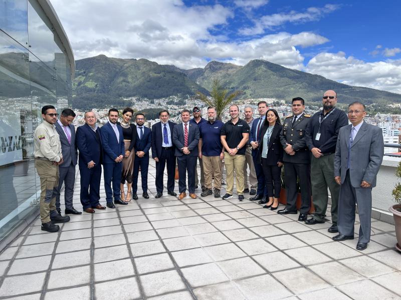 Group photo on balcony in front of mountains