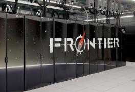 Photo of the front row of the Frontier supercomputer showing the Frontier logo. 