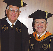 Carl Burtis (left), chief of clinical chemistry in the Health Services Division, receives an honorary doctorate of science degree from Martin C. Jischke, President of Purdue University, for his work in the field of biochemistry.