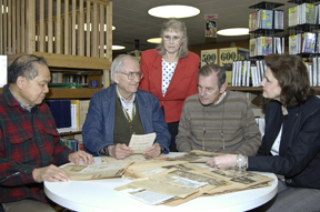 History room volunteers (from left) Bill Yee, Charles Congdon, Communications and External Relations' Debbie Dickerson and Steve Stow present the scrapbook to Kathy McNeilly, director of the Oak Ridge Public Library.