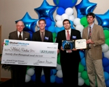 Tom Ballard, (left), director of ORNL Partnerships, and ORNL Director Thom Mason (far right) present $25,000 to Purdue University team members Isaac Wildeson and Carlos Kemeny for winning the 2009 Global Venture Challenge.