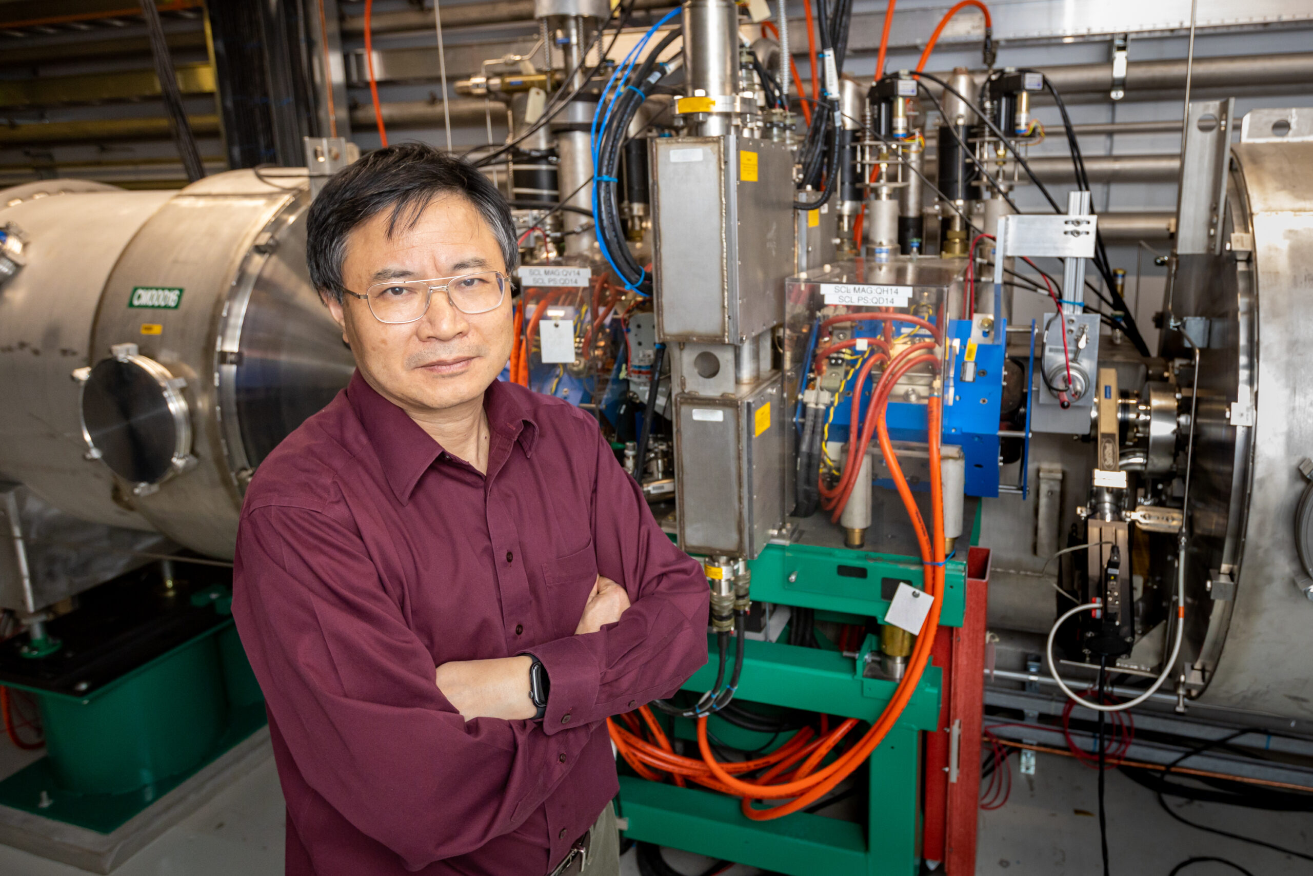 ORNL’s Yun Liu stands before one of the 10 laser comb-based beam diagnostics stations at the Spallation Neutron Source. The laser comb solves the longstanding problem of measuring changes in the beam across time. Credit: Genevieve Martin/ORNL, U.S. Dept. of Energy