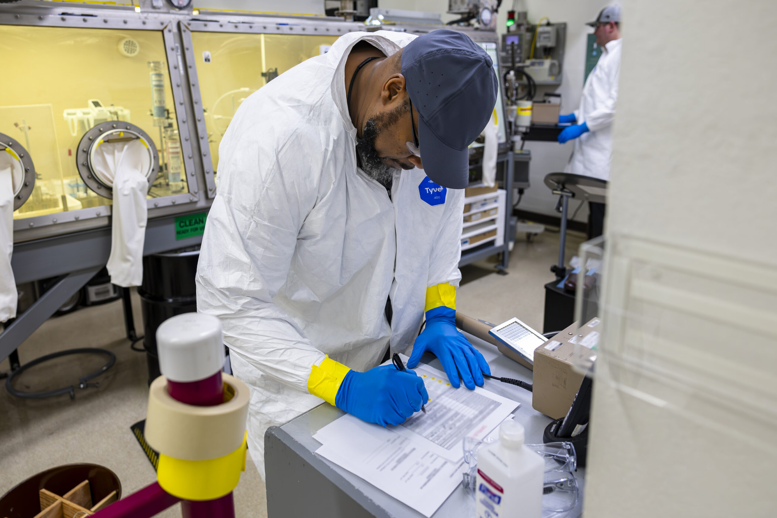 Technician Isaac Coleman reviews paperwork for a recent Ac-225 shipment prior to its release.