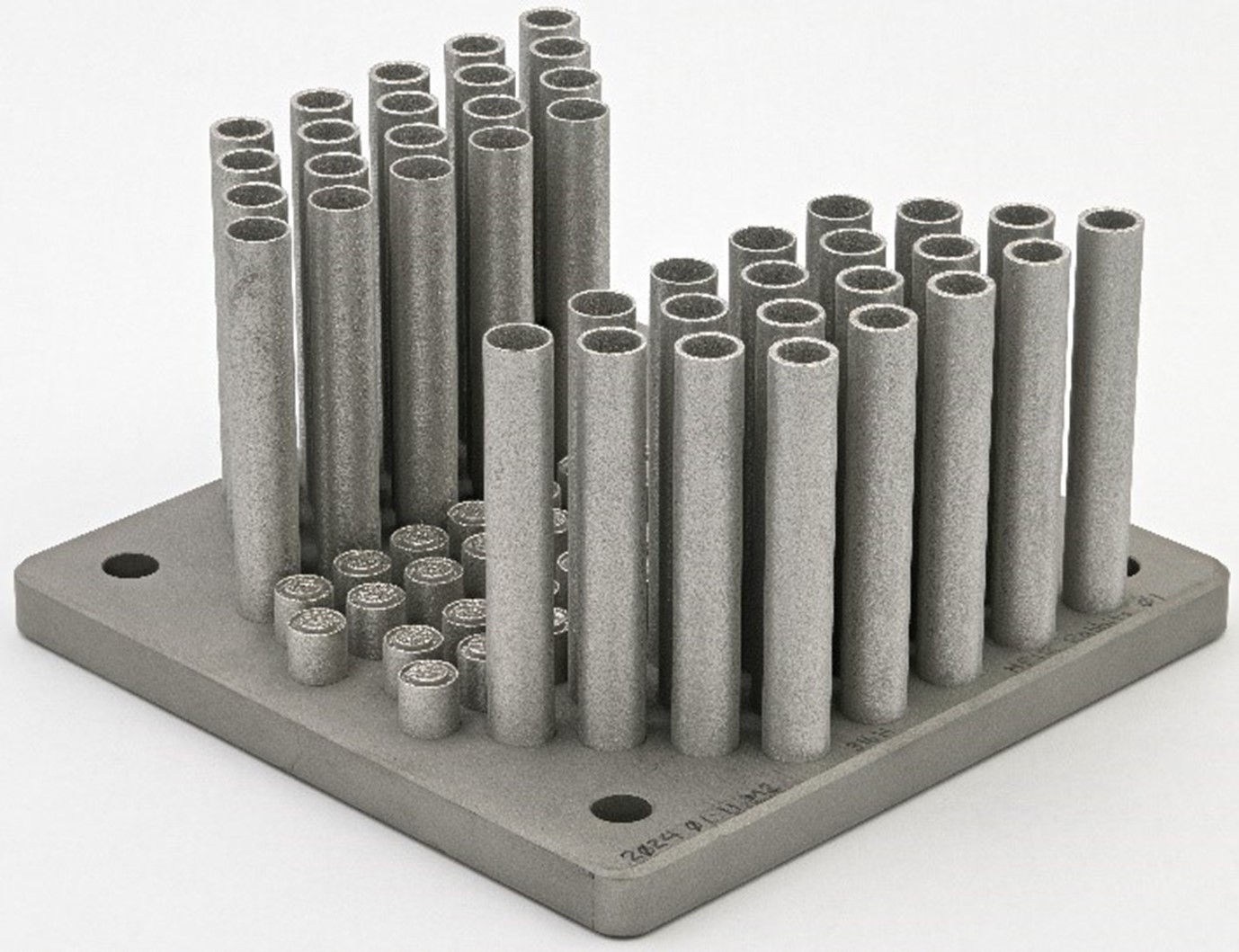 40 Stainless steel capsules 3D printed on a square board.