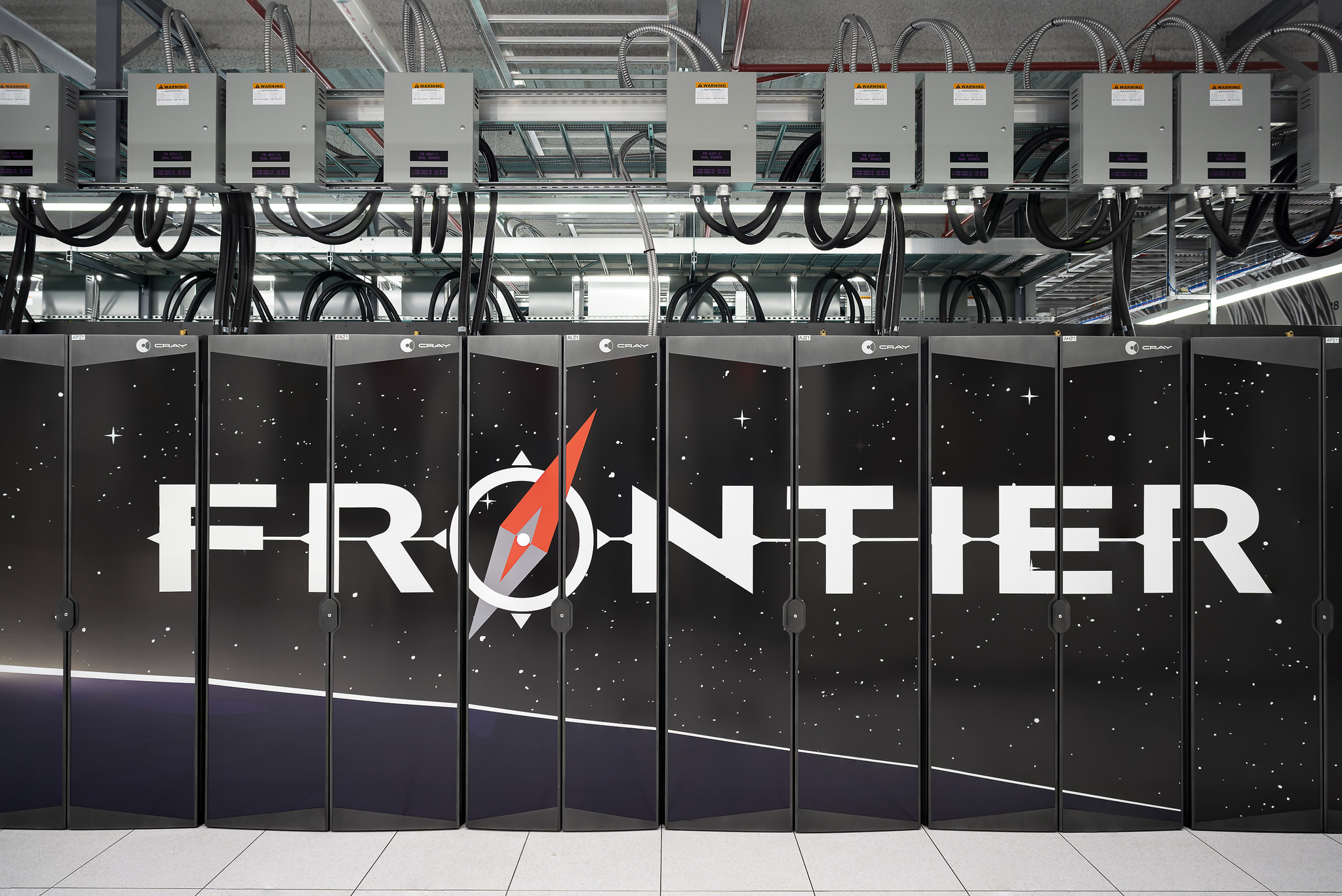 Frontier Supercomputer pictured with the logo written across the cabinets