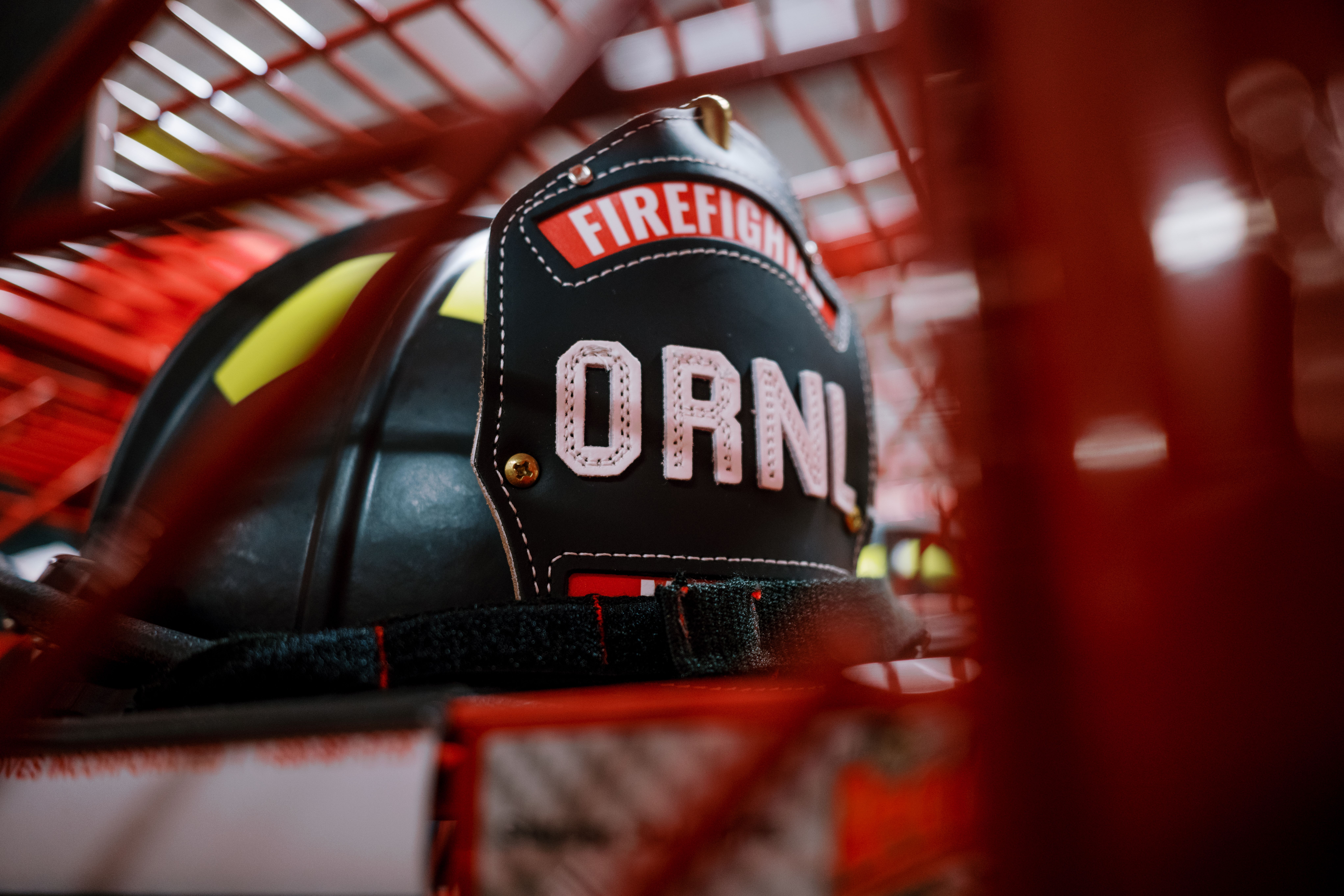 Firefighter helmet with “ORNL” lettering stored in a gear rack