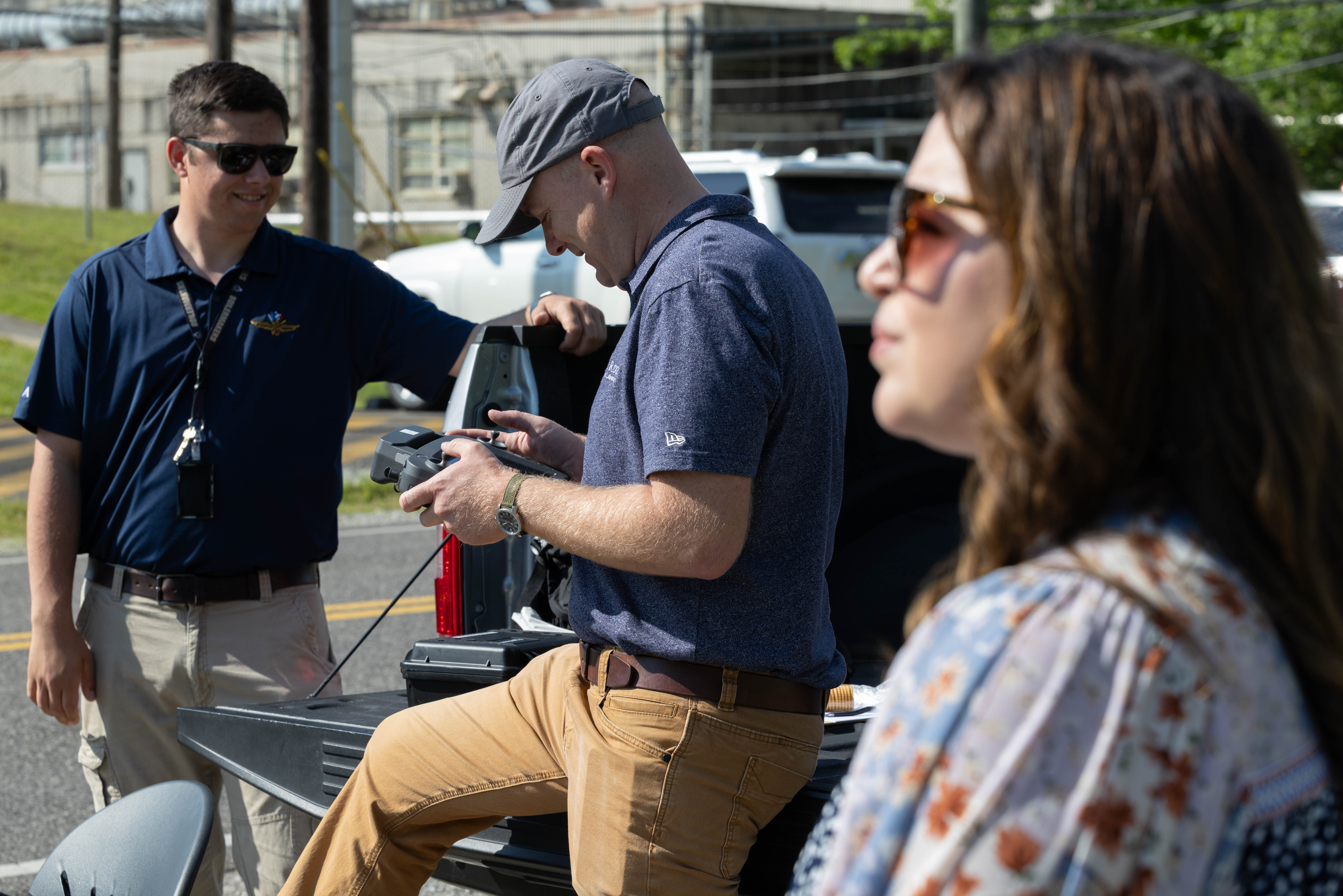 Zach Ryan, left, and Jairus Hines fly a drone capturing video of passing vehicle for a vehicle recognition project led by Sally Ghanem, right
