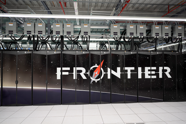 A wall of black panels with wiring at the top and the word FRONTIER written across the panels, in a room with a grey-tile floor.