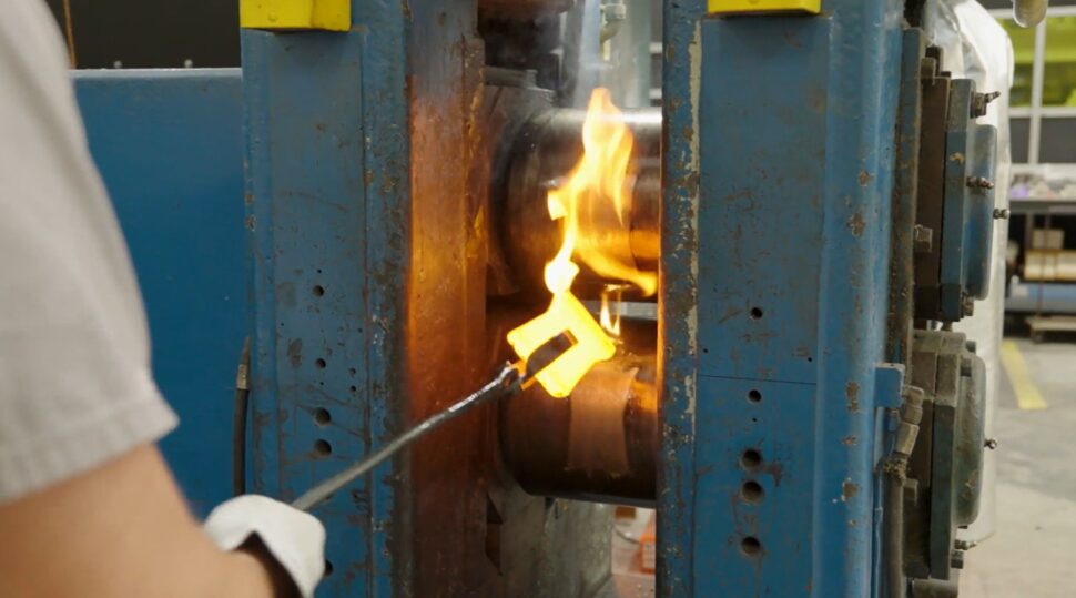 fire is shown between two tall blue columns
