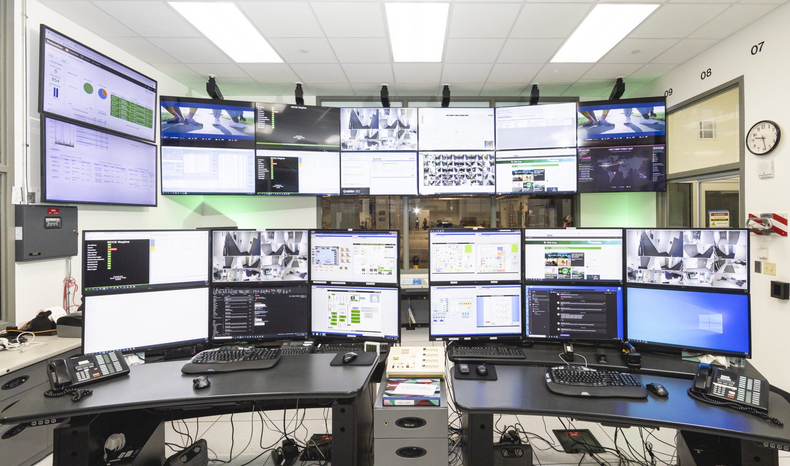 Large room of screens inside the supercomputer office