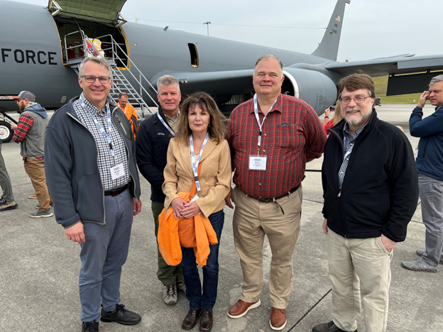 ORNL staff including 4 guys and one girl stand outside of the Bosslift airplane