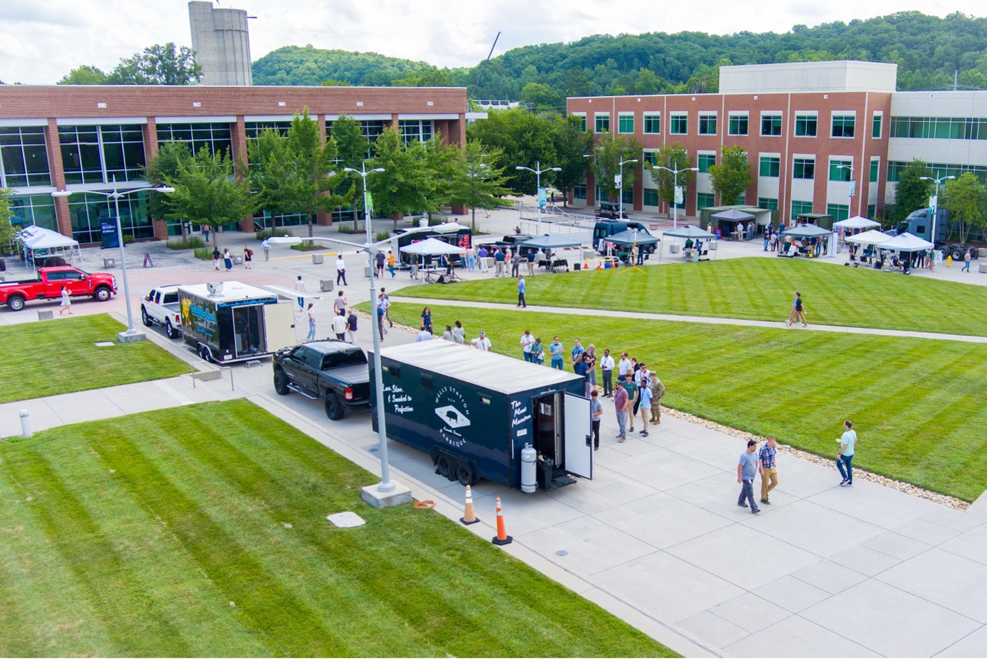 Overhead view of food trucks and sidewalks and green grass