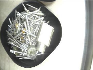 Tray filled with cut metal tube pieces and small components.