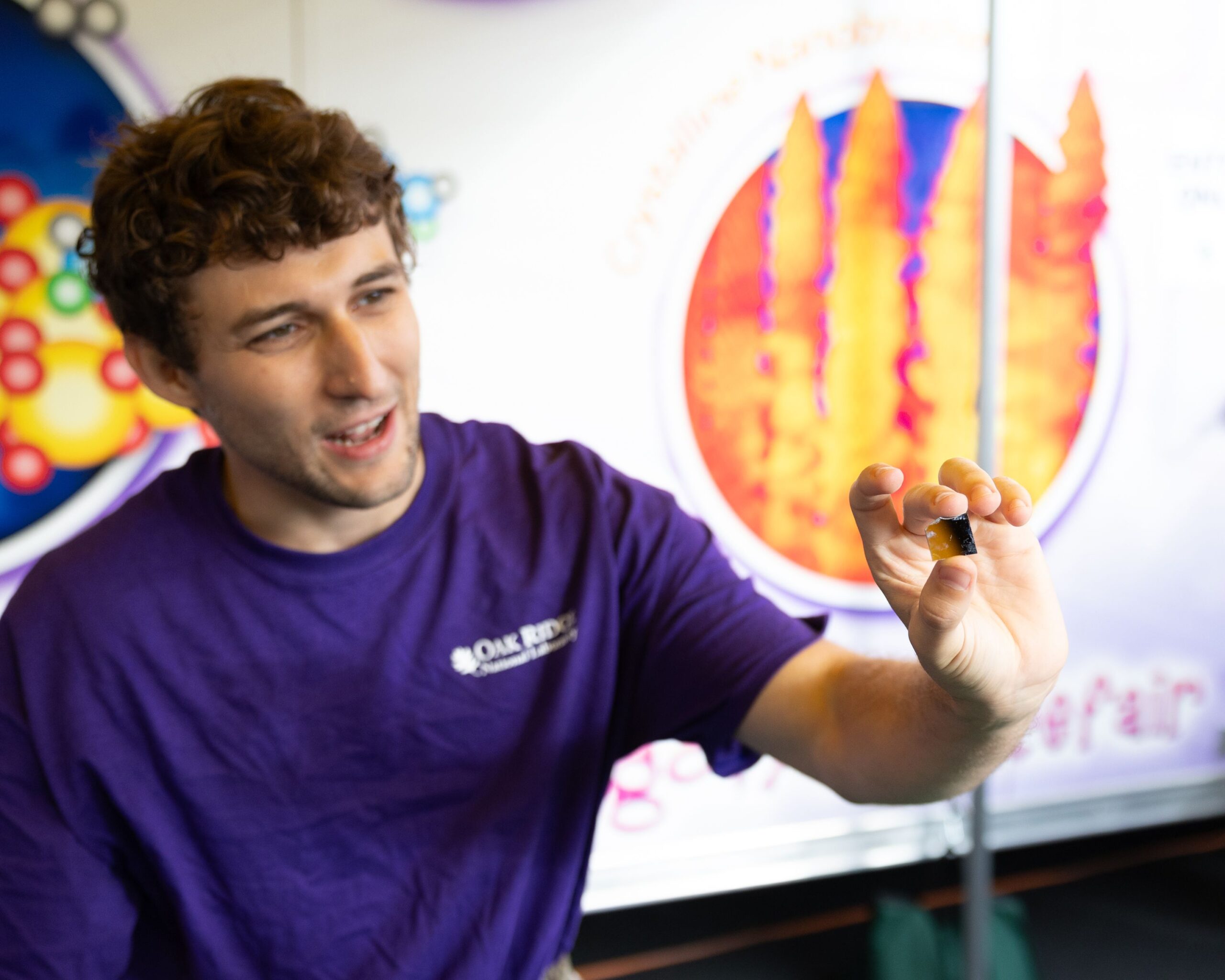 Scientist is holding up the world's smallest fidget spinners, the size of a human hair