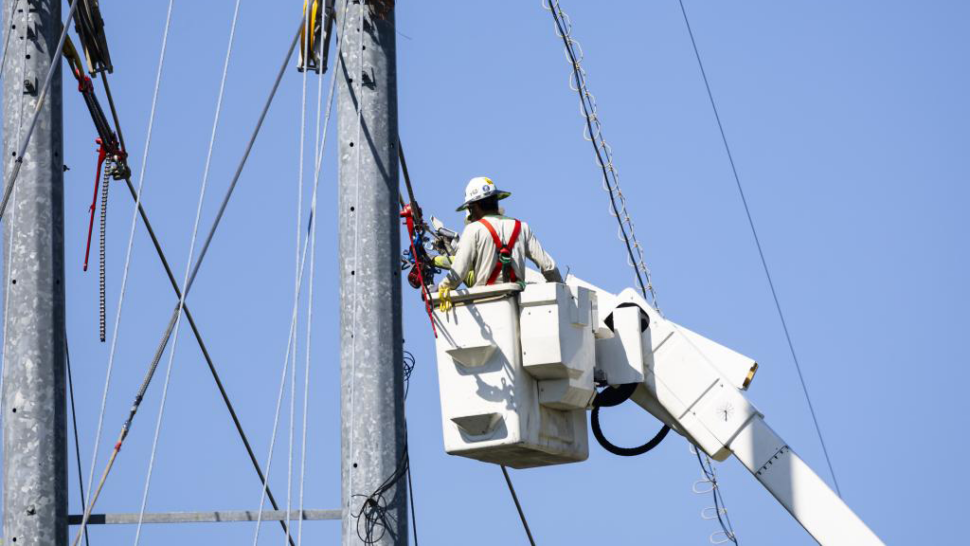 Hanging new coated power lines for the Power line Conductor Accelerated Testing Facility, PCAT, July 12, 2023. General Cable, a partner company, contracted with ORNL to provide testing of the effectiveness of power line coating by the company’s robot, using our PCAT facility on main campus.