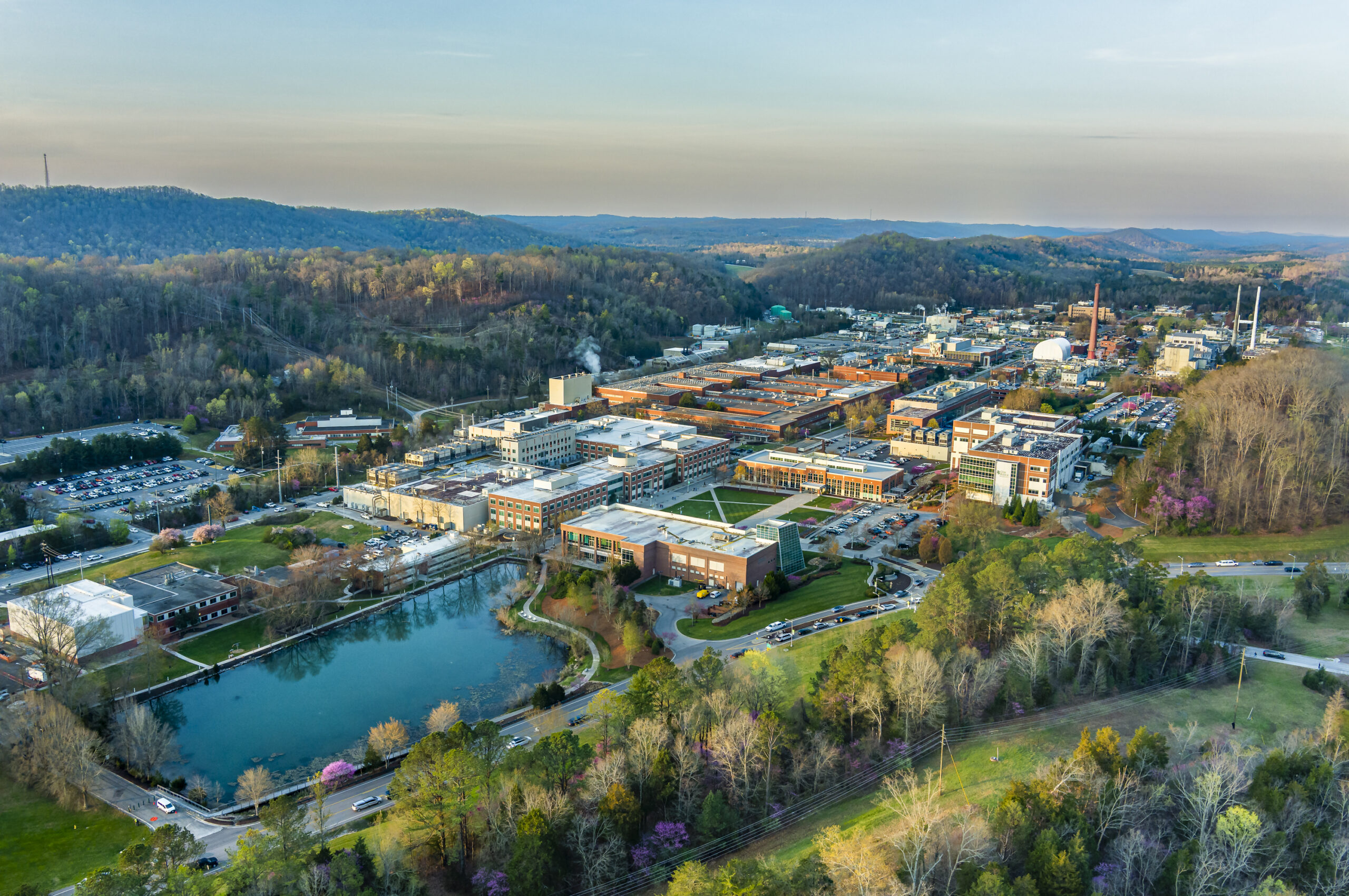 Sunrise aerial view of ORNL's main campus looking southwest with mountains in background