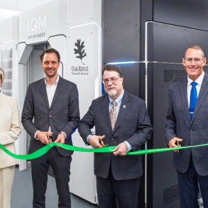 From left, Gina Tourassi, Jan Goetz, Stephen Streiffer and Trey Wheeler cut a ribbon during the opening ceremony for IQM’s quantum computing system at ORNL’s Translational Research Capability facility.