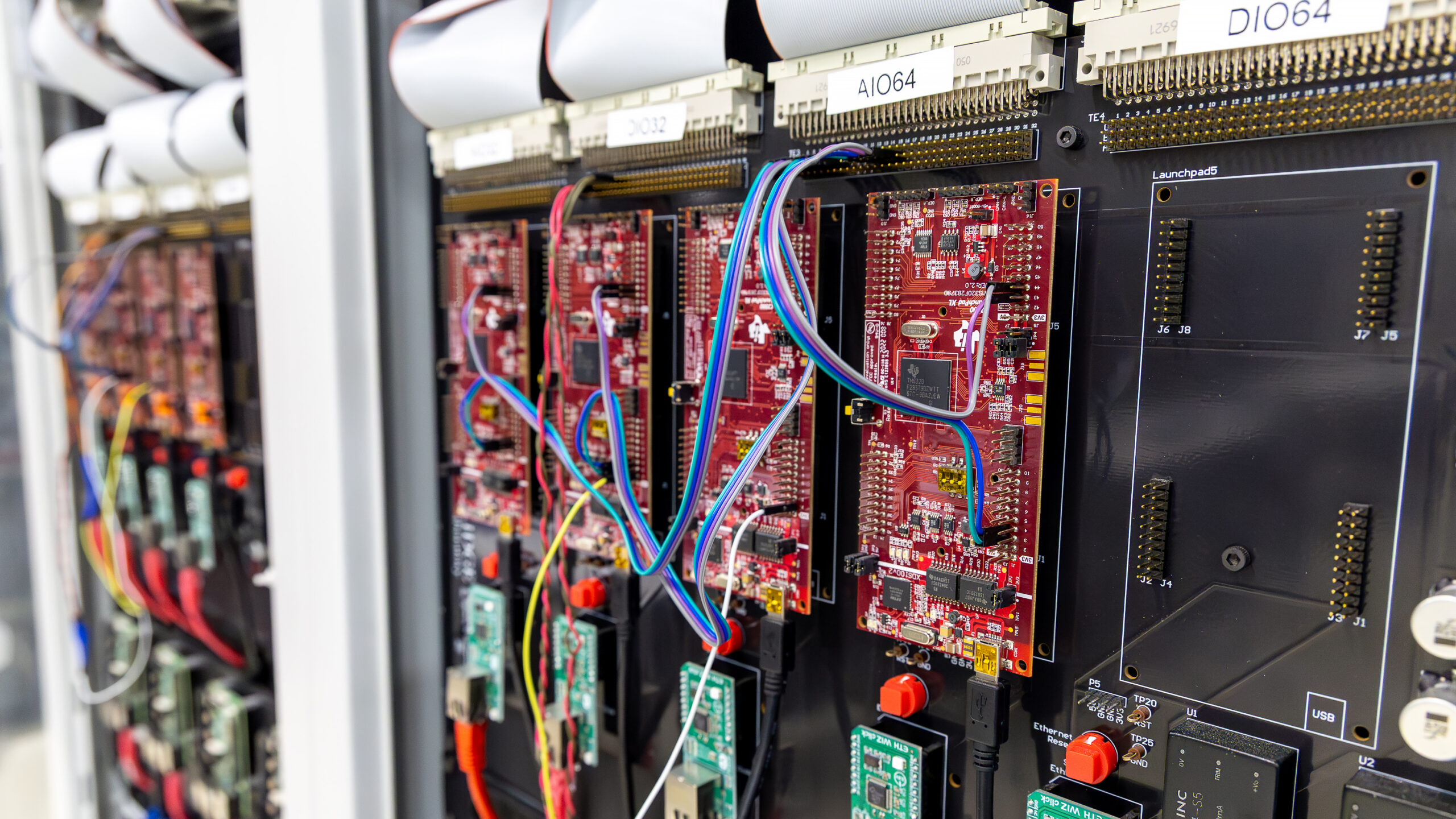Close-up of circuit boards, wiring and network connections mounted inside a test rack in the Hardware-in-the-Loop Protection Lab at Oak Ridge National Laboratory.
