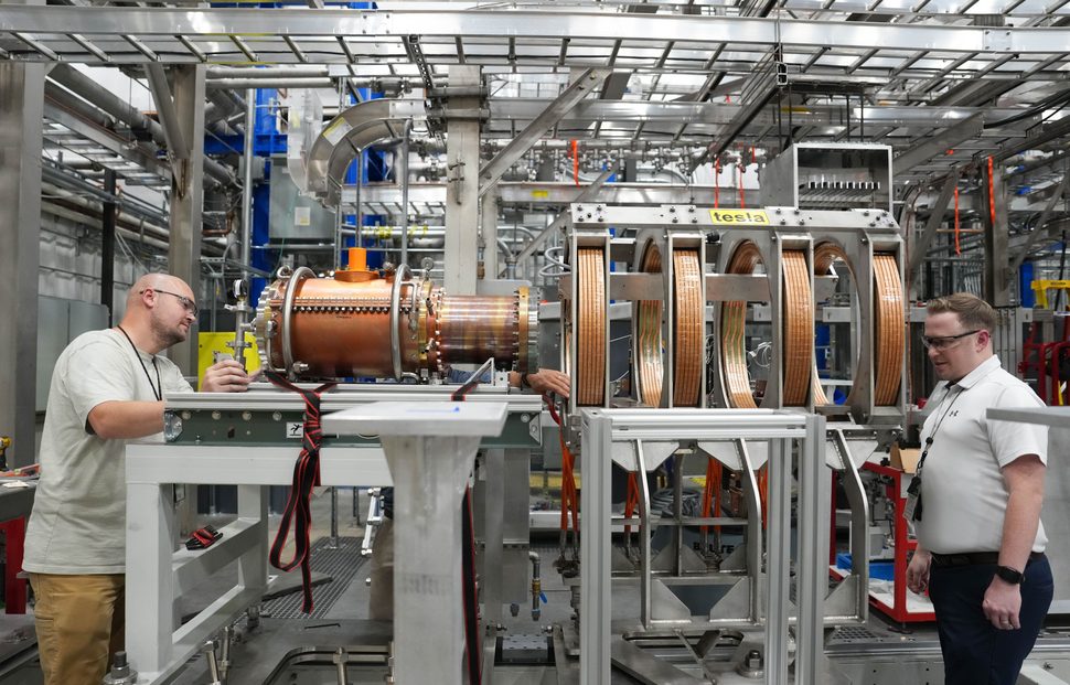 Matt Dessel oversees the placement of a large cylindrical superconducting magnet at ORNL’s Material Plasma Exposure Experiment facility.