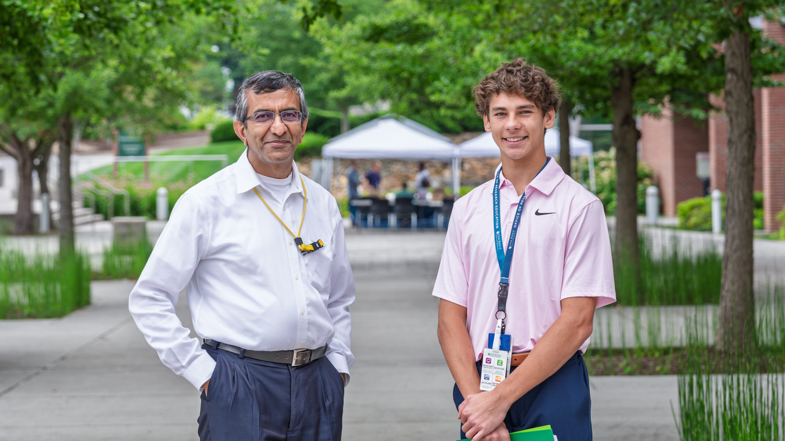 Dilipkumar Asthagiri, left, and Noah Harrison pose for a photo outside the cafeteria at ORNL.