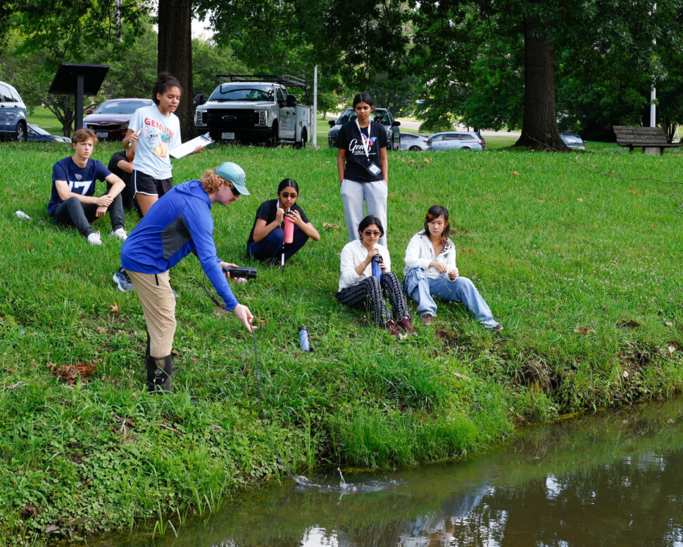 High school students collect and test creek water during a SAGE camp activity with Biological and Environmental Systems Science Directorate staff at Bissell Park.