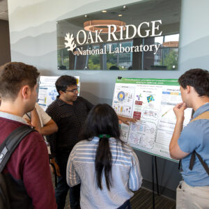 Manas Sajjan, Research Scientist in Quantum HPC Systems, discusses his research poster with conference attendees during the poster session at the 2026 Quantum Computing User Forum at Oak Ridge National Laboratory.