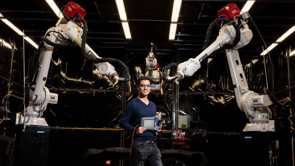 A man holds controls for MedUSA in the Manufacturing Demonstration Facility.
