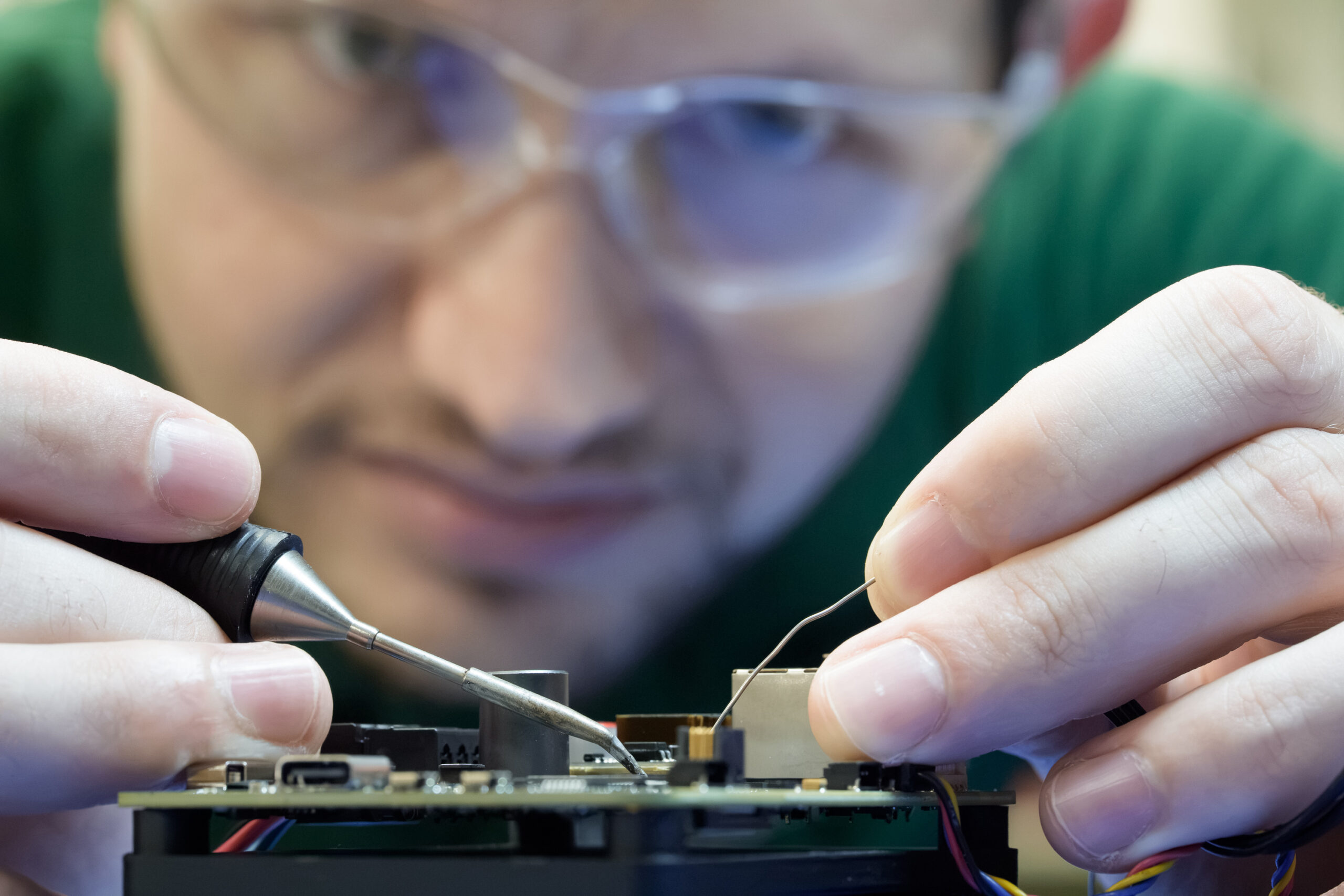 Close-up of a researcher working on the device’s electronics.