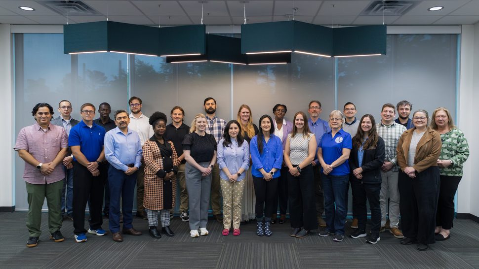Group photo of 23 participants attending the 2026 PRO-AR&FC annual team meeting in Building 2040 on May 6, 2026. The front row includes Jay Joshi, David Chandler, Sunil Chirayath, Christina Prah, Louise Evans, Cansu On, Birdy Phathanapirom, Annie Berens, Becky Chamberlin, Katie Mummah, and Hannah Hale. The back row includes Tom Hanlon, Evans Kitcher, Dylan Ohrt, Nathan Hofmeister, Mathew Swinney, Karen Hogue, Tomi Akindele, Steve Skutnik, Matt Dunbrack, Nick Hubley, Andy Prince, and Laura Weeks.