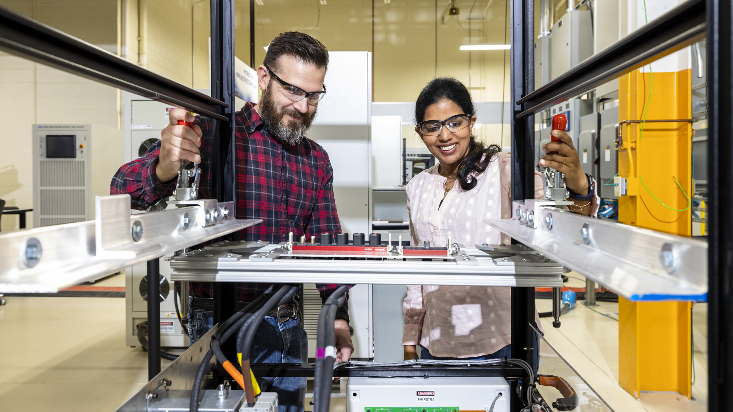 Radha Krishna Moorthy and Steven Campbell working with converter system at GRID-C.